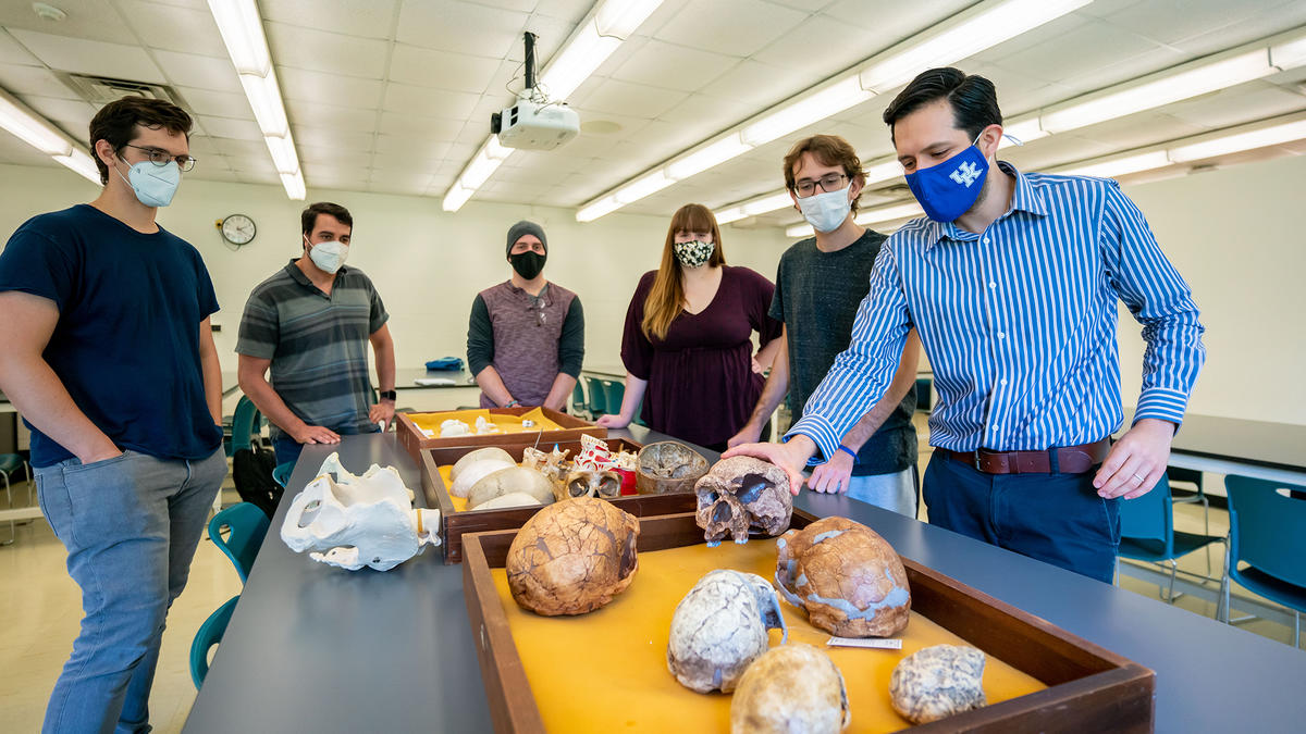 (From left) James Keppeler, Daniel Benitez, Marcus Rodriguez, Leah Blair, Bruno Athie Teruel and Hugo Reyes-Centeno, assistant professor of anthropology, examine artifacts from his human fossil record research. Photo Courtesy: UK Research.
