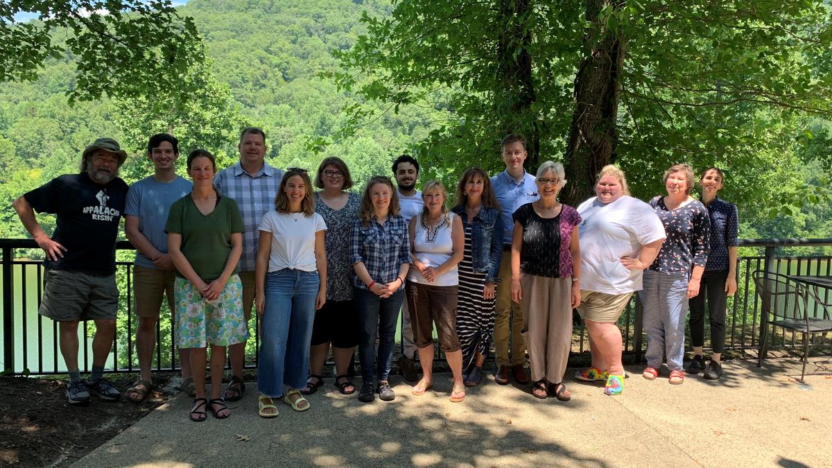 Outside members of the community university team assemble for a research and planning retreat.