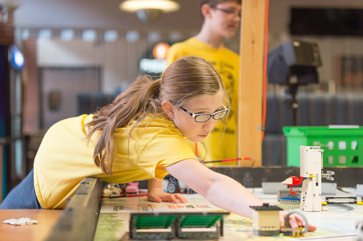 Young student at Eday exploring a lego display.