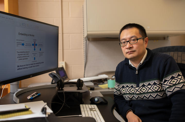 Qing Shao in office in front of computer screen