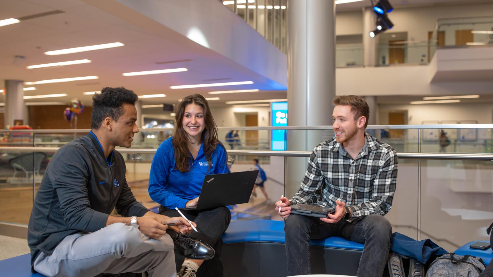 Group of three engineering students socializing 