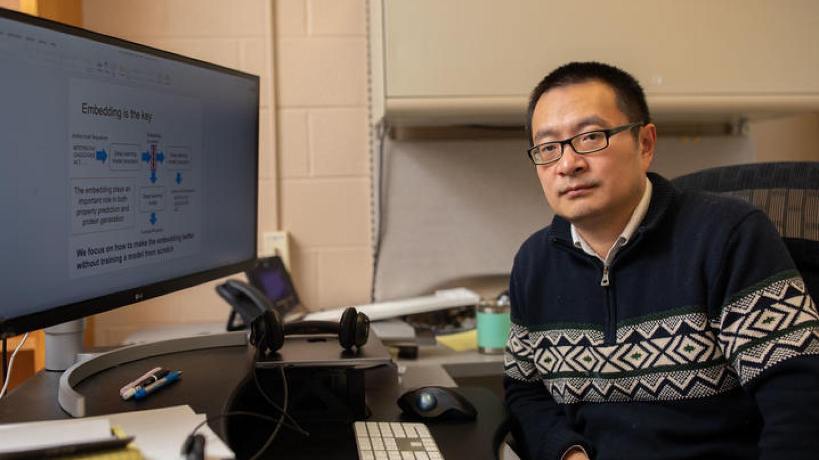 Qing Shao in office in front of computer screen