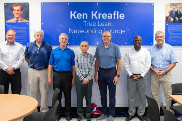 Dean Buchheit (left) with Lean Systems Program leadership and Jeff Stryker in front of dedication plaques