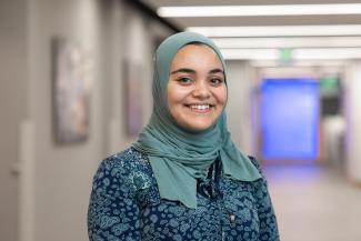 Professional headshot of Amna Al-Jumaily.