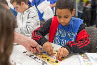 Young student building a lego project.