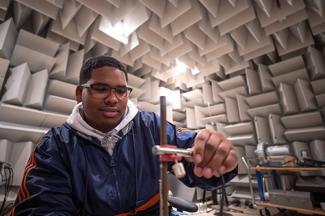 Student working in an anechoic chamber.