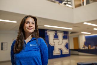 Student standing in front of UK sign