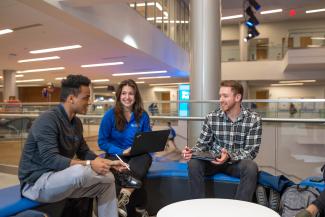 Group of three engineering students socializing 