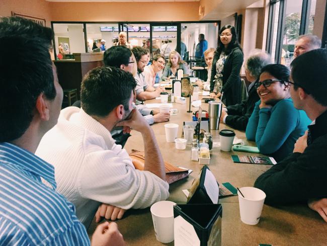 Members listen on while undergraduate BMES member Tasneem Naheyan presents the background research her team prepared for the day.