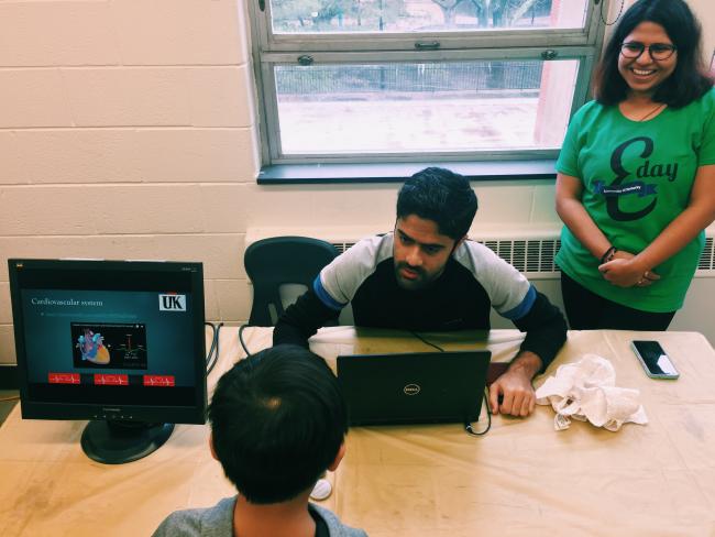 Javad Mollakazemi (left) and Dibyajyoti Biswal (right) educated E-day attendees on the electrical activity of the heart and how it can be monitored.