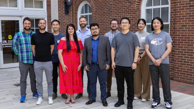 10 Faculty Members standing in a line