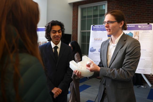 Student holding prototype