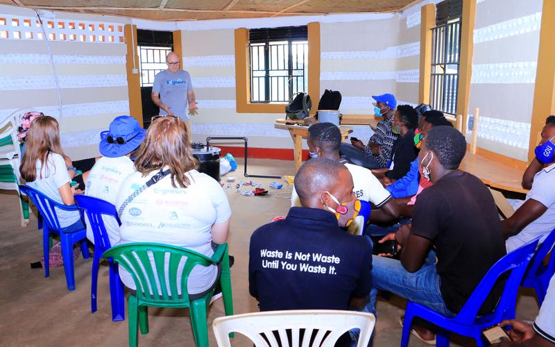 Professor Jeff Seay conducts a training session on the Trash-to-Tank Processor for the staff of Upcycle Africa in Mpigi, Uganda.