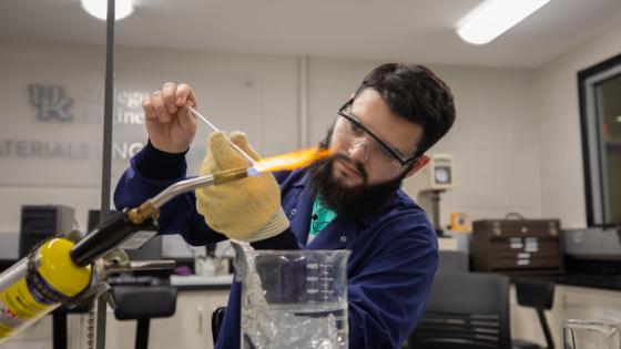 Student in Materials Science Lab with blow torch and melting glass