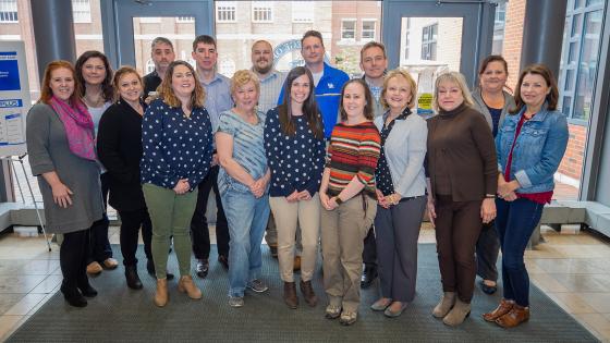 Staff council members standing together in the lobby of the RGAN building.