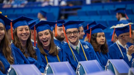 3 students in graduation cap and gowns