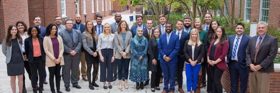 Young Alumni Philanthropy Council group members posing together in the Engineering courtyard with Dean Rudy Buchheit.