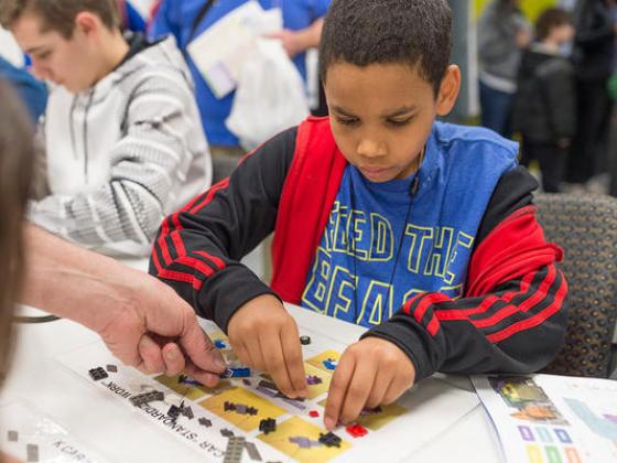 Young student building a lego project.